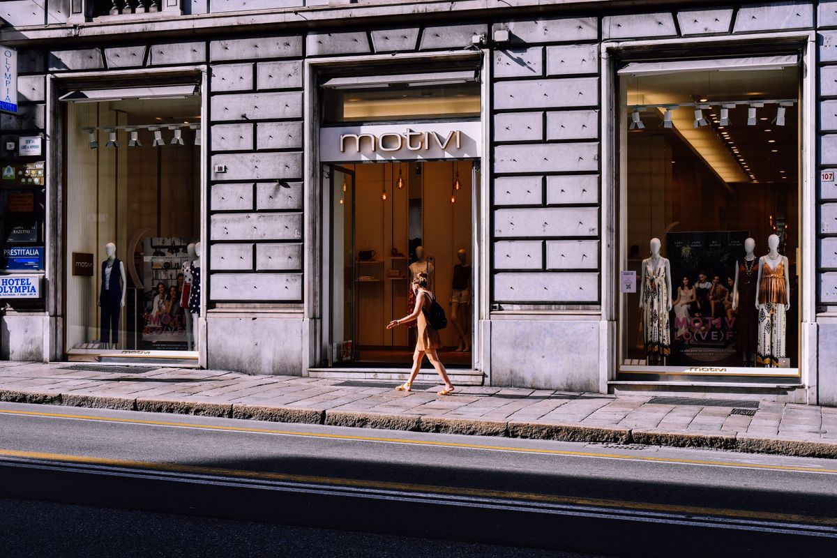 A woman browsing supportive bras at a store to find her large-bust size
