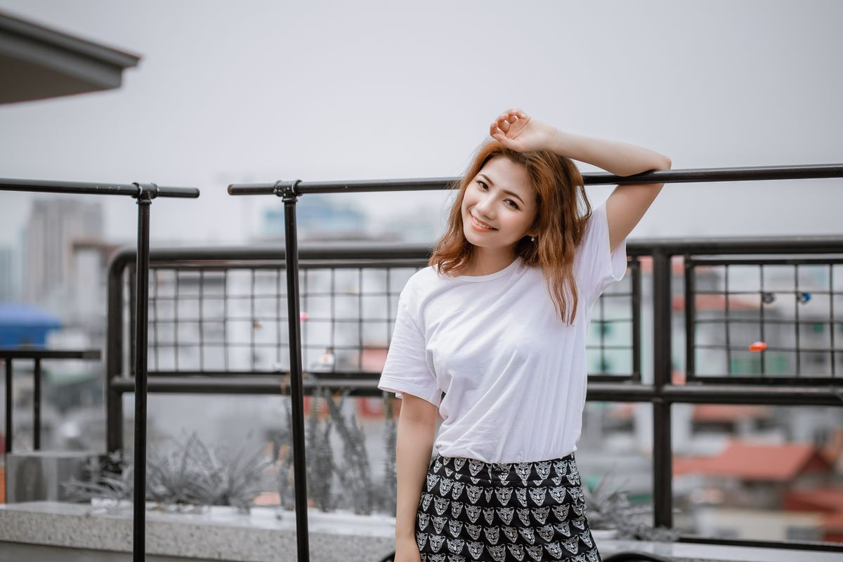 A relaxed woman in a white t-shirt, showing the effortless comfort of a bralette