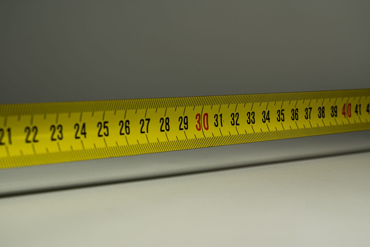 A yellow measuring tape with centimetre marks, used to check a sister size band