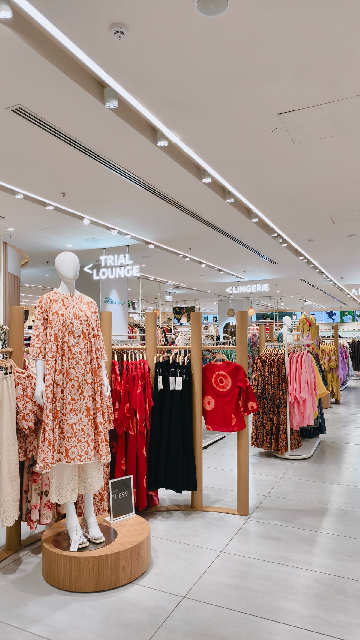 The lingerie section of a clothing store, with fitting rooms signposted nearby