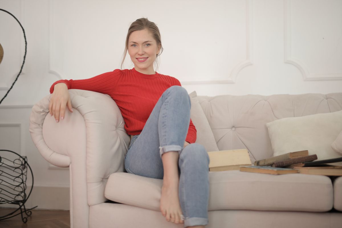 A woman relaxing comfortably at home in a soft sweater
