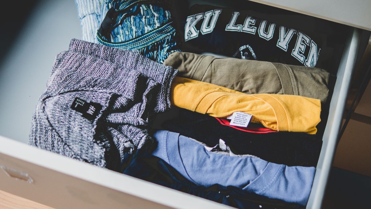 Folded clothes neatly stacked in a drawer, a reminder to rotate and replace worn bras