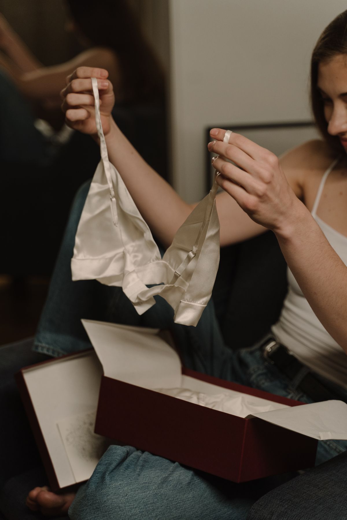 A woman inspecting the cups of a new bra she has just unwrapped