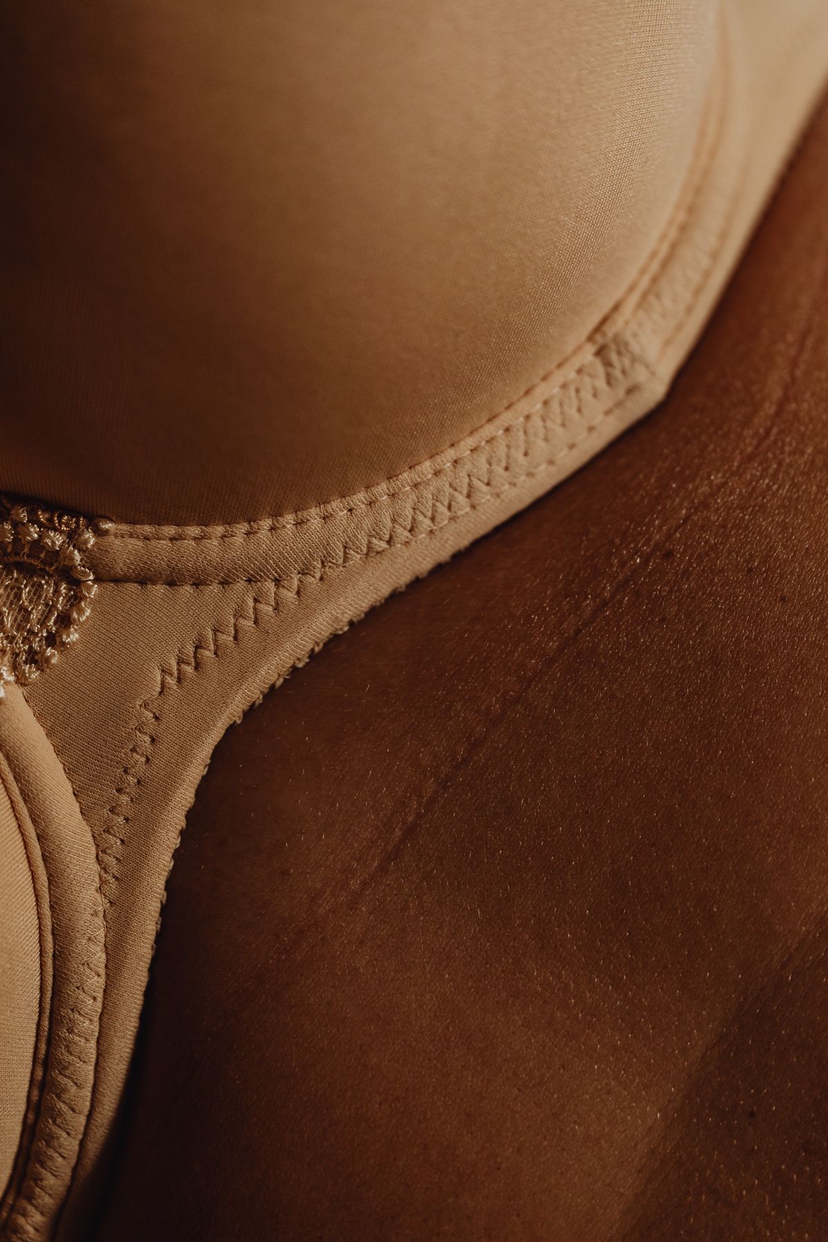 Close-up of a bra worn on the body, showing both cups meeting at the centre gore panel against the chest