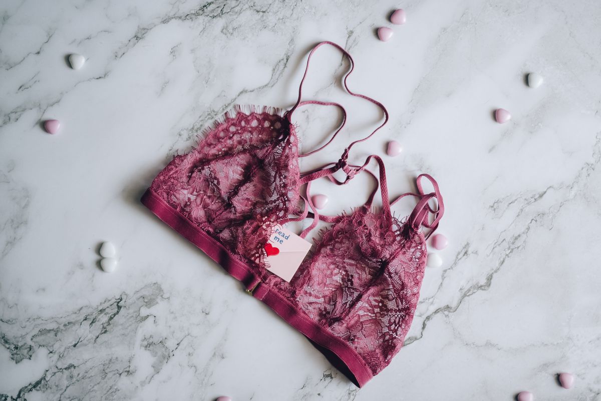 A flat-lay bra on a marble surface, showing the cup where breast spillage happens