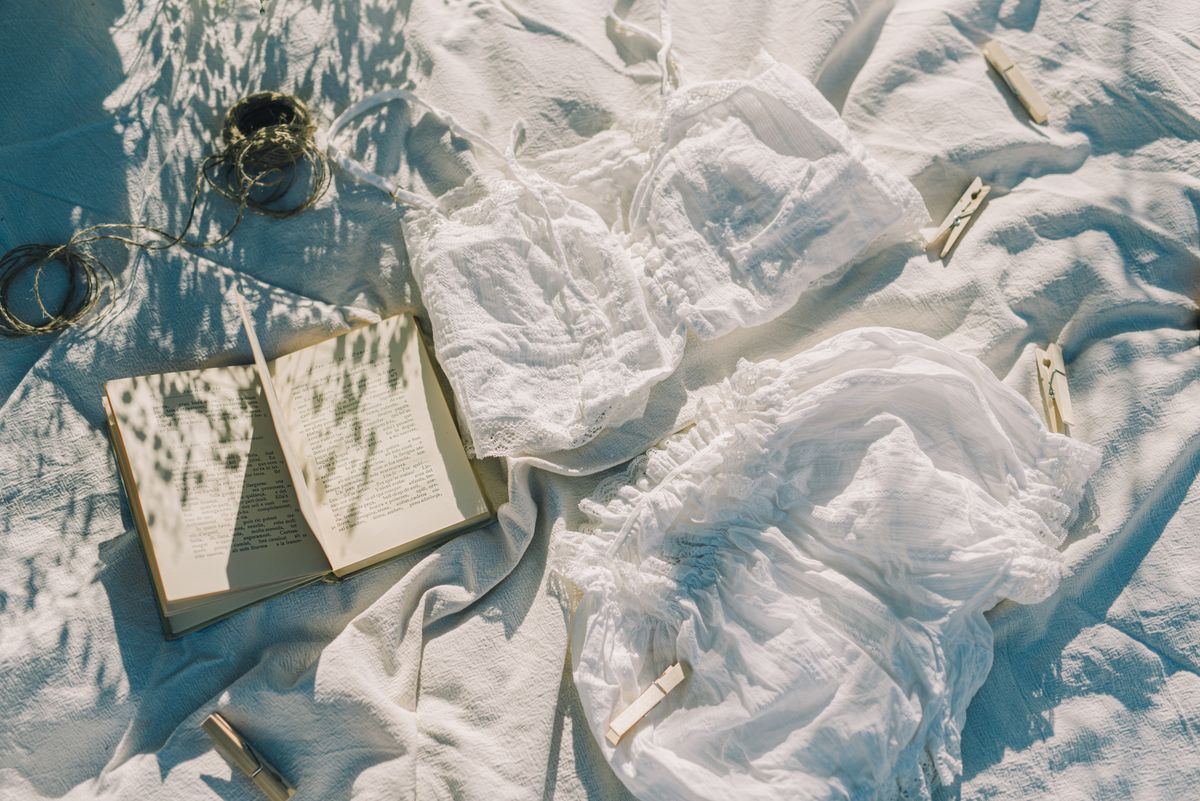 A flat lay of lingerie with a book, illustrating a bra center gore that floats