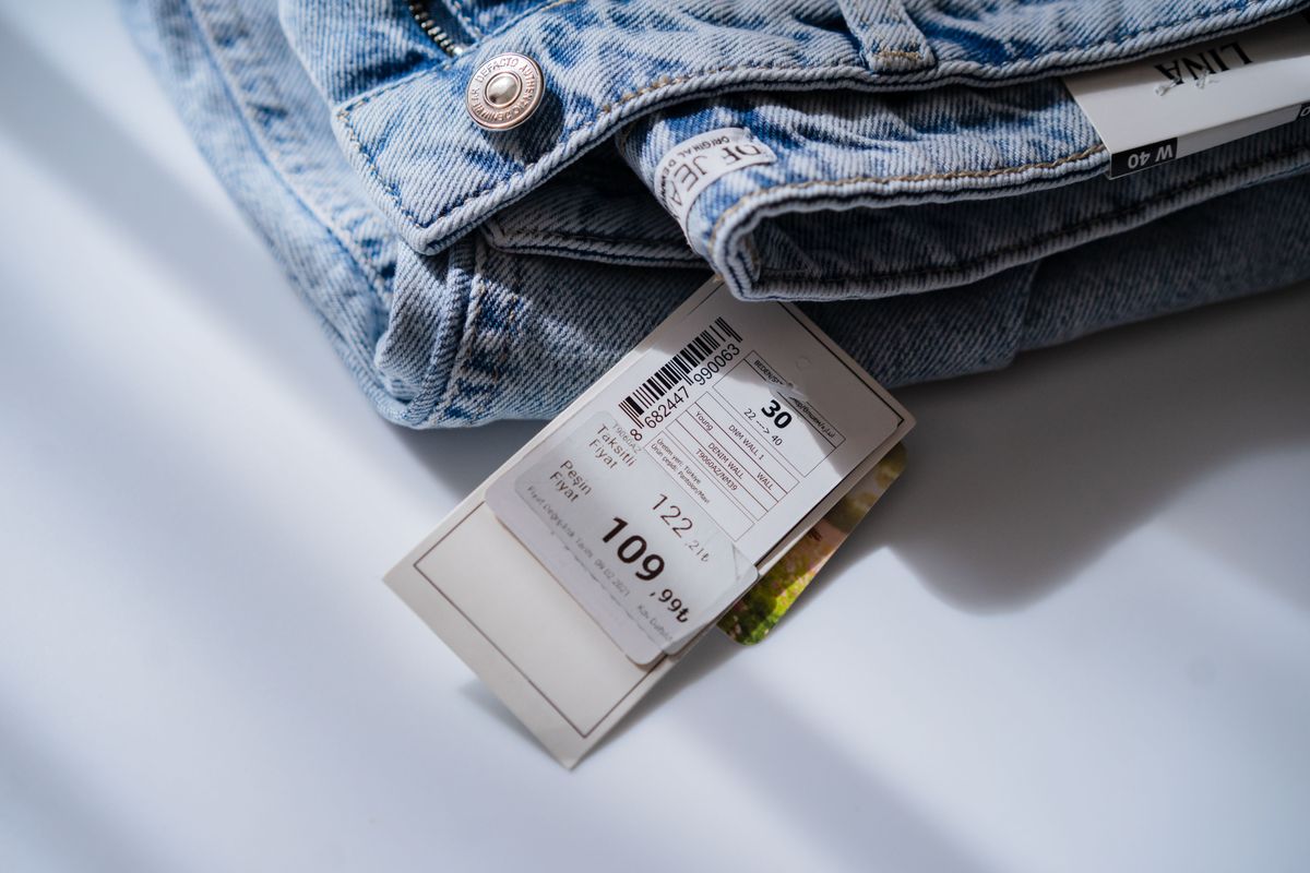Folded denim with a visible size label, showing how sister size charts work