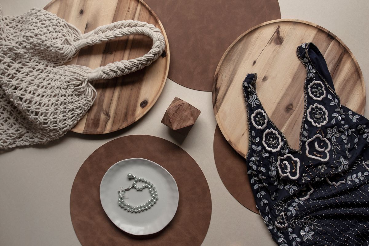 A flat lay of clothing and accessories for choosing a bra for a small bust