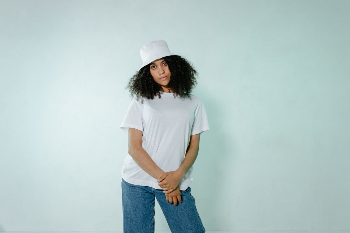 A young woman in a white t-shirt, showing a smooth bra line under everyday clothing