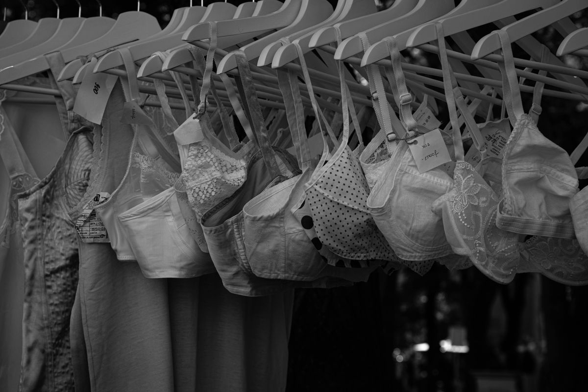 A variety of bra styles on hangers, comparing demi and full cup options