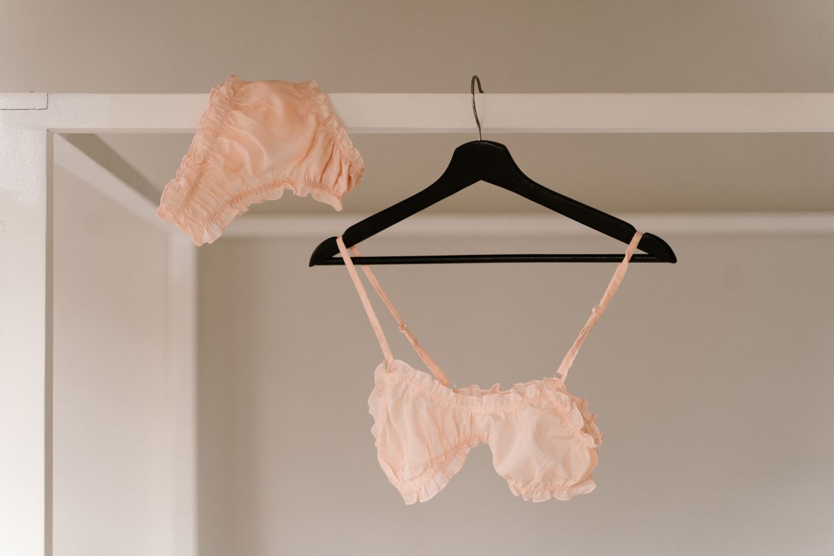 A lace bra laid flat, with the center gore panel between the cups