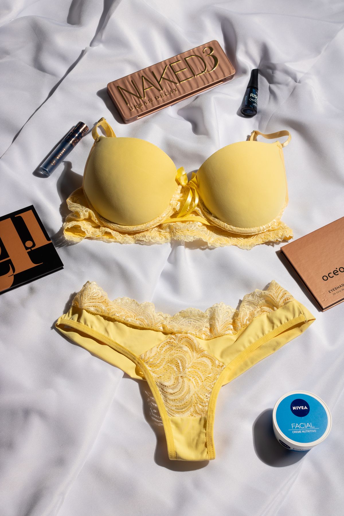 A yellow padded bra laid flat, showing two smooth moulded bra cups joined by the centre panel