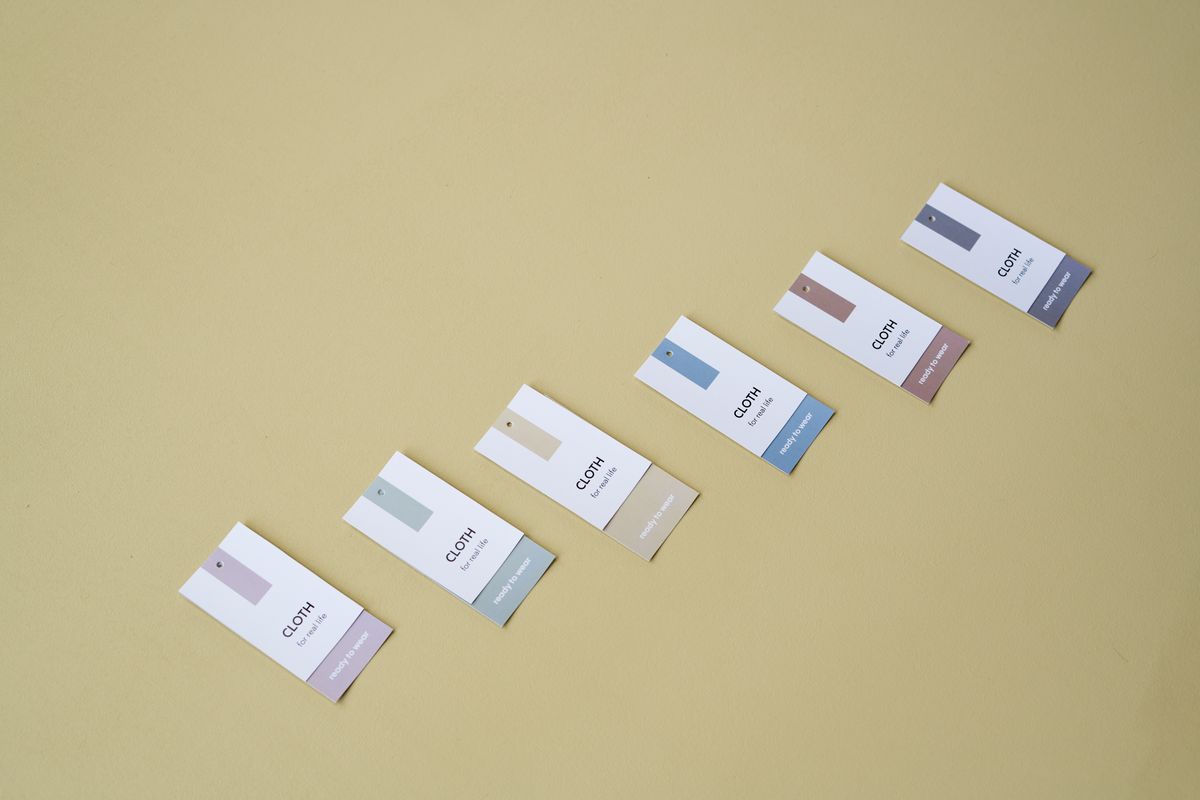 Colourful clothing size tags, illustrating how bra sister sizing works