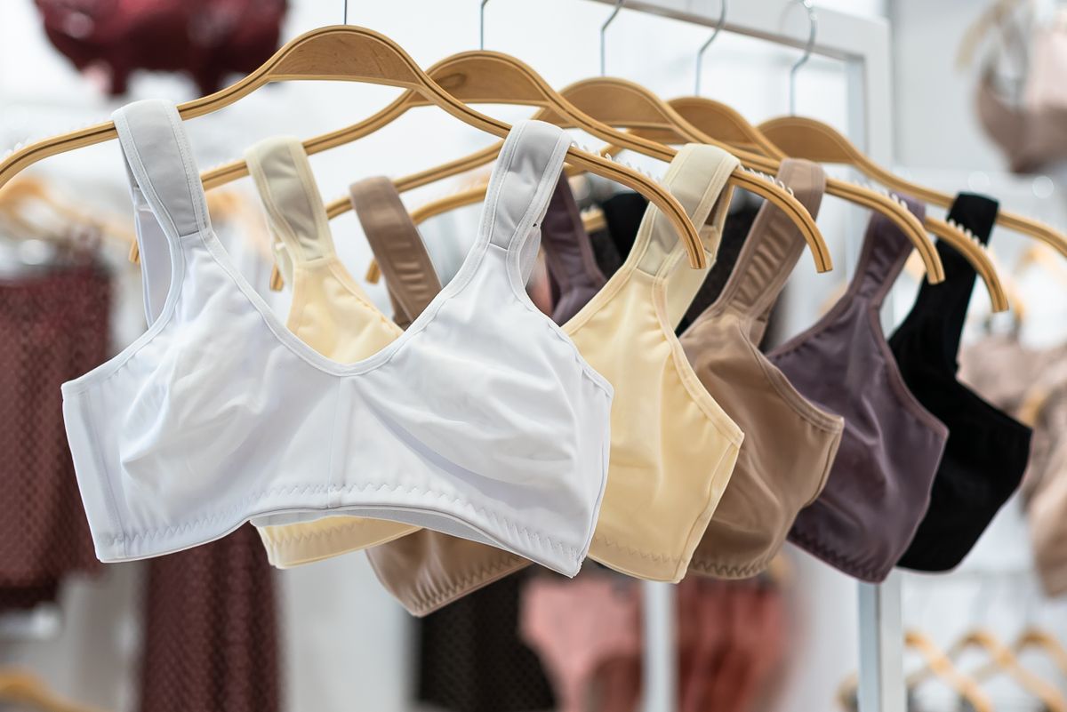 Several bras in different cuts hanging on a rack, showing styles that fix breast spillage